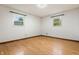 Bright bedroom featuring hardwood floors, white walls, and two windows letting in natural light at 8140 Valley Estates Dr, Indianapolis, IN 46227
