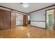 Bedroom features wood floors, traditional wallpaper, and closet space, creating a cozy, classic interior at 8140 Valley Estates Dr, Indianapolis, IN 46227