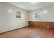 Bedroom with hardwood floors, two windows, and wainscoting, offering simple style and natural light at 8140 Valley Estates Dr, Indianapolis, IN 46227