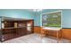 Multi-level bonus room with table and large window offering outside tree views at 8140 Valley Estates Dr, Indianapolis, IN 46227
