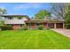 Charming home with brick and vinyl siding, a covered porch, and an attached garage at 8140 Valley Estates Dr, Indianapolis, IN 46227