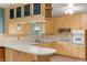 Bright eat-in kitchen boasts wood cabinets, light countertops, and stainless steel appliances for efficient cooking at 8140 Valley Estates Dr, Indianapolis, IN 46227