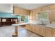 Bright kitchen boasts wood cabinets, light countertops, peninsula, and modern flooring for a functional and stylish cooking space at 8140 Valley Estates Dr, Indianapolis, IN 46227