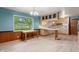 Cozy kitchen with wood cabinets, modern appliances, and a breakfast bar next to a table at 8140 Valley Estates Dr, Indianapolis, IN 46227