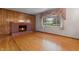 Inviting living room featuring a brick fireplace and large windows, with hardwood floors at 8140 Valley Estates Dr, Indianapolis, IN 46227