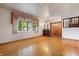 Bright living room featuring hardwood floors and a large window with decorative curtains at 8140 Valley Estates Dr, Indianapolis, IN 46227