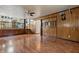 Spacious living room with wood paneling, a ceiling fan, and stairs to another level at 8140 Valley Estates Dr, Indianapolis, IN 46227