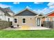 Charming backyard featuring a small wooden deck and grassy lawn at 829 Olive St, Indianapolis, IN 46203