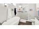 Bright bathroom featuring a soaking tub, glass enclosed shower, and modern fixtures at 829 Olive St, Indianapolis, IN 46203