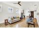 Bright living room with hardwood floors, neutral tones, and open layout to kitchen and dining area at 829 Olive St, Indianapolis, IN 46203