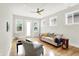 Cozy living room with hardwood floors, comfortable seating, and ample natural light streaming through the windows at 829 Olive St, Indianapolis, IN 46203
