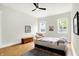 Tranquil main bedroom featuring hardwood floors, ample lighting, and a cozy sitting area for unwinding after a long day at 829 Olive St, Indianapolis, IN 46203