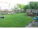 Backyard features a green lawn, mature trees, a wood deck, and a wood fence at 8551 Walden Trace Dr, Indianapolis, IN 46278