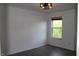 A simple bedroom has a modern light fixture, new paint, and a window that brings in natural light at 8551 Walden Trace Dr, Indianapolis, IN 46278