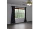 Bright bedroom featuring wood-look flooring, a ceiling fan, and a large window with backyard views at 8551 Walden Trace Dr, Indianapolis, IN 46278
