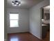 Bright dining area featuring wood floors, a large window, and an open view to the kitchen at 8551 Walden Trace Dr, Indianapolis, IN 46278