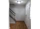 Bright foyer featuring wood floors, a staircase, and a white front door with glass panels at 8551 Walden Trace Dr, Indianapolis, IN 46278