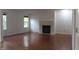 Spacious living room with wood floors, a fireplace, and large windows providing natural light at 8551 Walden Trace Dr, Indianapolis, IN 46278