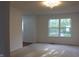 Carpeted living room with large windows providing natural light and a view to the entry at 8551 Walden Trace Dr, Indianapolis, IN 46278