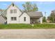 Quaint two-story home featuring a covered porch and a classic white exterior on a green lawn at 907 S Ohio St, Sheridan, IN 46069