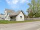 Charming two-story home with a covered porch, white siding, and a mature tree in the yard at 907 S Ohio St, Sheridan, IN 46069