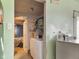 Laundry area next to the bedroom, featuring a washer, dryer, and laundry supplies at 907 S Ohio St, Sheridan, IN 46069