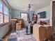Unfinished living room filled with cardboard boxes and featuring a ceiling fan and carpeted flooring at 907 S Ohio St, Sheridan, IN 46069