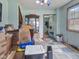 Cluttered living room with cardboard boxes, dated carpet, and view of a staircase at 907 S Ohio St, Sheridan, IN 46069