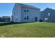 Spacious backyard with lush green lawn and exterior view of the two-story home at 9074 Larson Dr, Pendleton, IN 46064