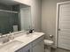 Bright bathroom featuring double sinks, quartz countertops, a large mirror, and a glass-enclosed shower at 9074 Larson Dr, Pendleton, IN 46064
