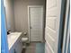 Bright bathroom with a large mirror, gray tile floor, white fixtures, and toilet at 9074 Larson Dr, Pendleton, IN 46064