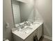 Bathroom featuring double sinks, white cabinets and hardware, with white countertops at 9074 Larson Dr, Pendleton, IN 46064