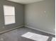 An empty bedroom features neutral-toned walls, carpet, and a window with blinds at 9074 Larson Dr, Pendleton, IN 46064
