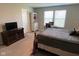 Bedroom featuring neutral walls, a bed, desk, and TV stand, creating a relaxing and functional space at 9074 Larson Dr, Pendleton, IN 46064