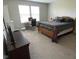 Spacious bedroom with a bed, desk, and dresser, offering a comfortable and functional living space at 9074 Larson Dr, Pendleton, IN 46064