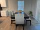 Open dining area with a dark wood table, upholstered chairs, and a plant at 9074 Larson Dr, Pendleton, IN 46064