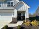 Cozy front porch with brick detail and inviting seating, adjacent to a three-car garage at 9074 Larson Dr, Pendleton, IN 46064