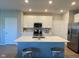 Bright kitchen featuring white cabinets, stainless steel appliances, and a center island at 9074 Larson Dr, Pendleton, IN 46064