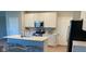 Modern kitchen featuring stainless steel appliances, white cabinetry, an island and laminate floors at 9074 Larson Dr, Pendleton, IN 46064