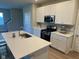 Bright kitchen featuring stainless steel appliances, white cabinetry, an island and laminate floors at 9074 Larson Dr, Pendleton, IN 46064