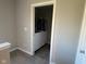 A laundry closet features a side-by-side washer and dryer and clothes on hangers at 9074 Larson Dr, Pendleton, IN 46064