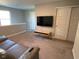 Cozy living room featuring a leather sofa, a flatscreen TV and neutral walls at 9074 Larson Dr, Pendleton, IN 46064