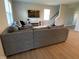 Bright living room featuring a comfortable gray couch, large TV, and access to the staircase at 9074 Larson Dr, Pendleton, IN 46064