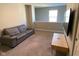 Cozy living room featuring a leather sofa, a flatscreen TV and neutral walls at 9074 Larson Dr, Pendleton, IN 46064