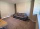 Cozy living room featuring a leather sofa, a flatscreen TV and neutral walls at 9074 Larson Dr, Pendleton, IN 46064