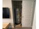 A gray water heater is tucked away inside a utility closet with bi-fold doors at 9074 Larson Dr, Pendleton, IN 46064