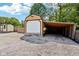 View of the barn with siding and garage door with an attached awning at 9510 N Cooney Rd, Mooresville, IN 46158