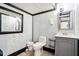 This bathroom features a dark trim with gray walls, a gray vanity and a toilet at 9510 N Cooney Rd, Mooresville, IN 46158