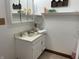 Bathroom vanity with sink, mirror, and toiletries displayed on shelving at 9510 N Cooney Rd, Mooresville, IN 46158