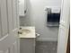 Compact bathroom featuring a sink, toilet, towel rack, and built-in storage at 9510 N Cooney Rd, Mooresville, IN 46158
